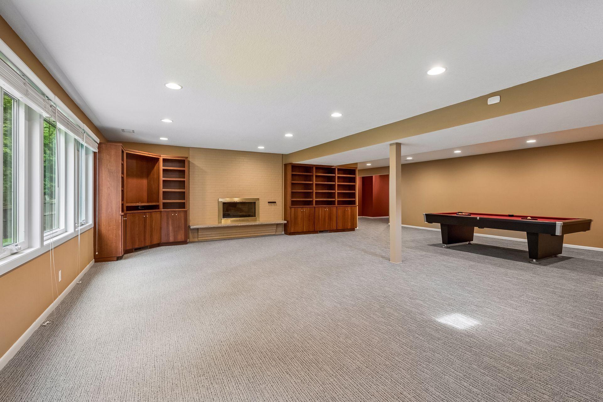 Lower-level wood-burning fireplace with built-ins.