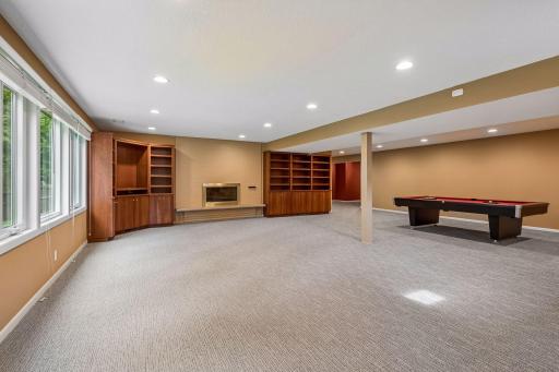 Lower-level wood-burning fireplace with built-ins.