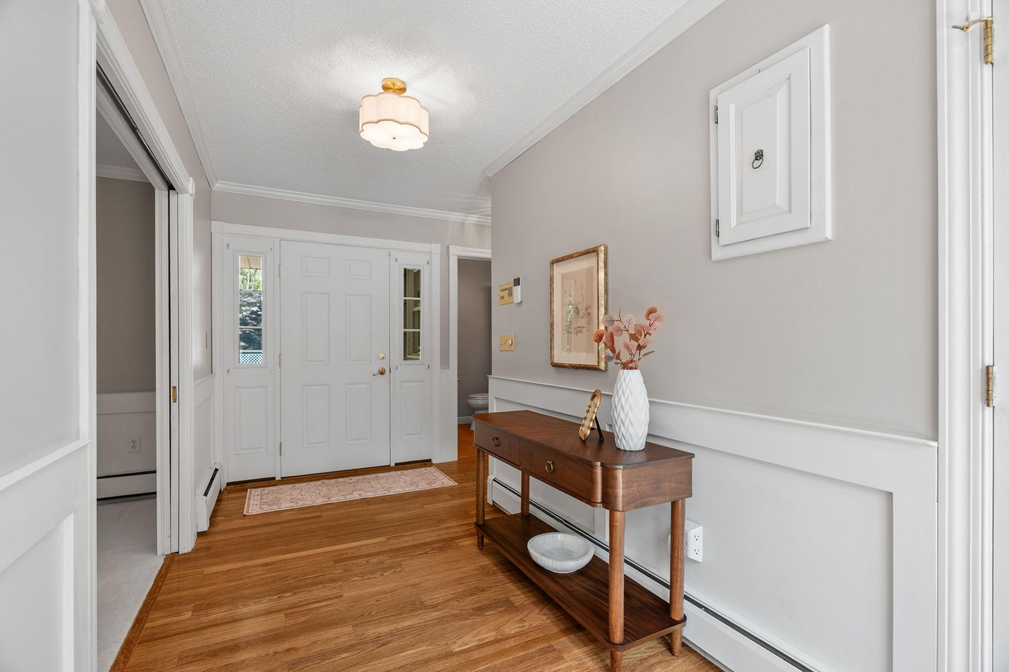 Additional view of the foyer with updated entry light and fresh paint.
