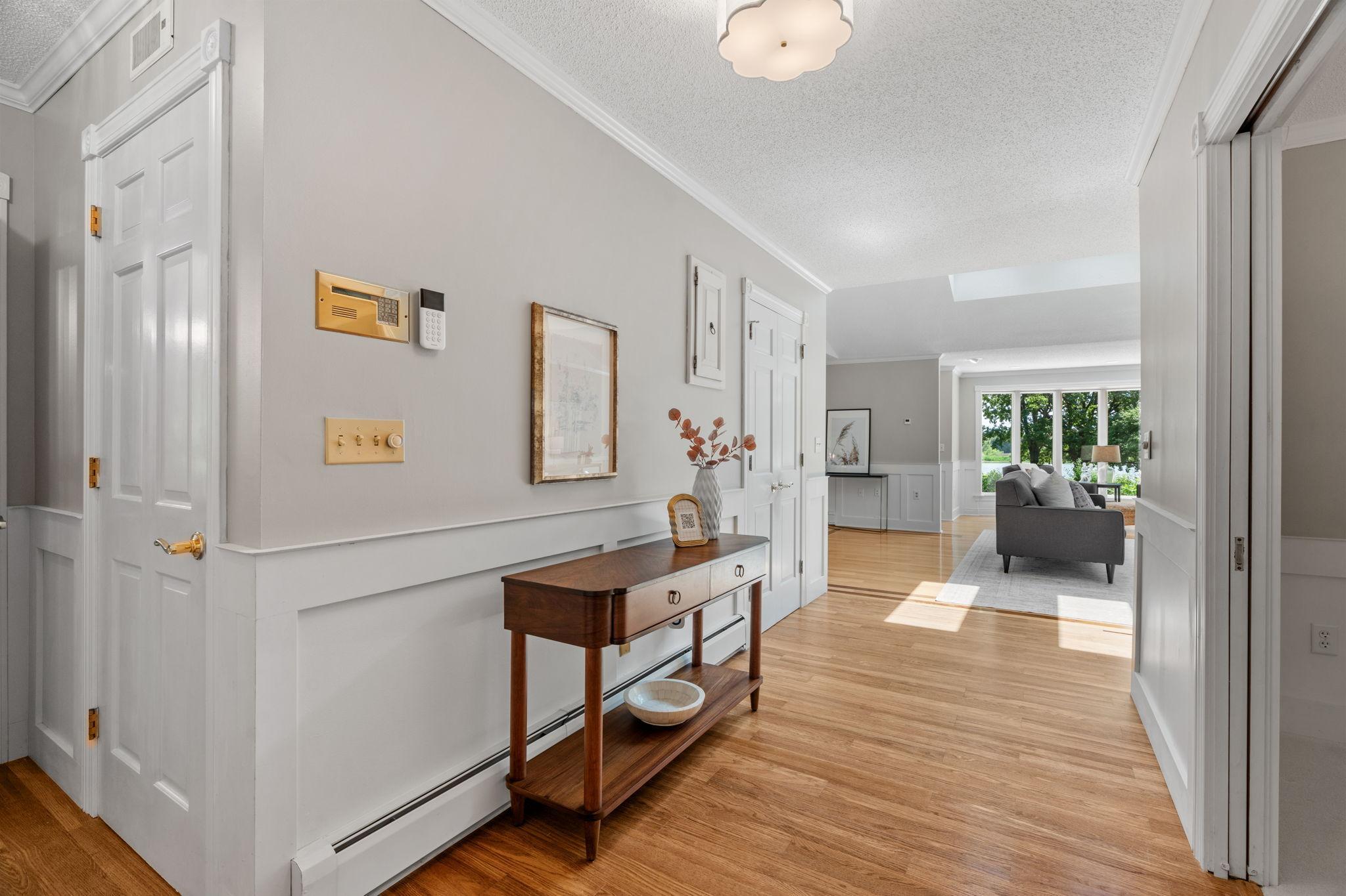 Step into your open and bright home. The foyer provides a peek to the stunning river views from the living room.