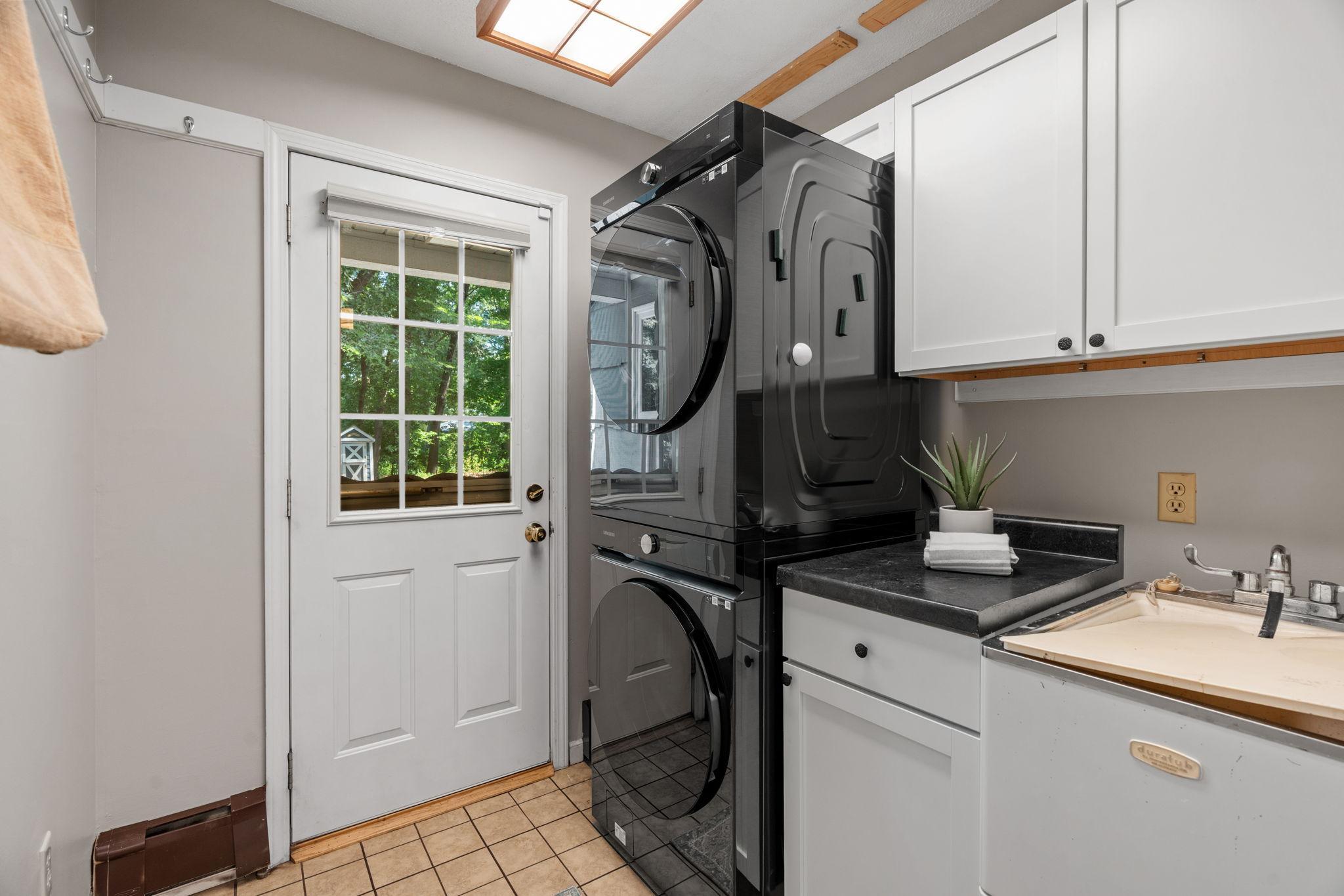 Main level laundry room and sink with access to the yard.