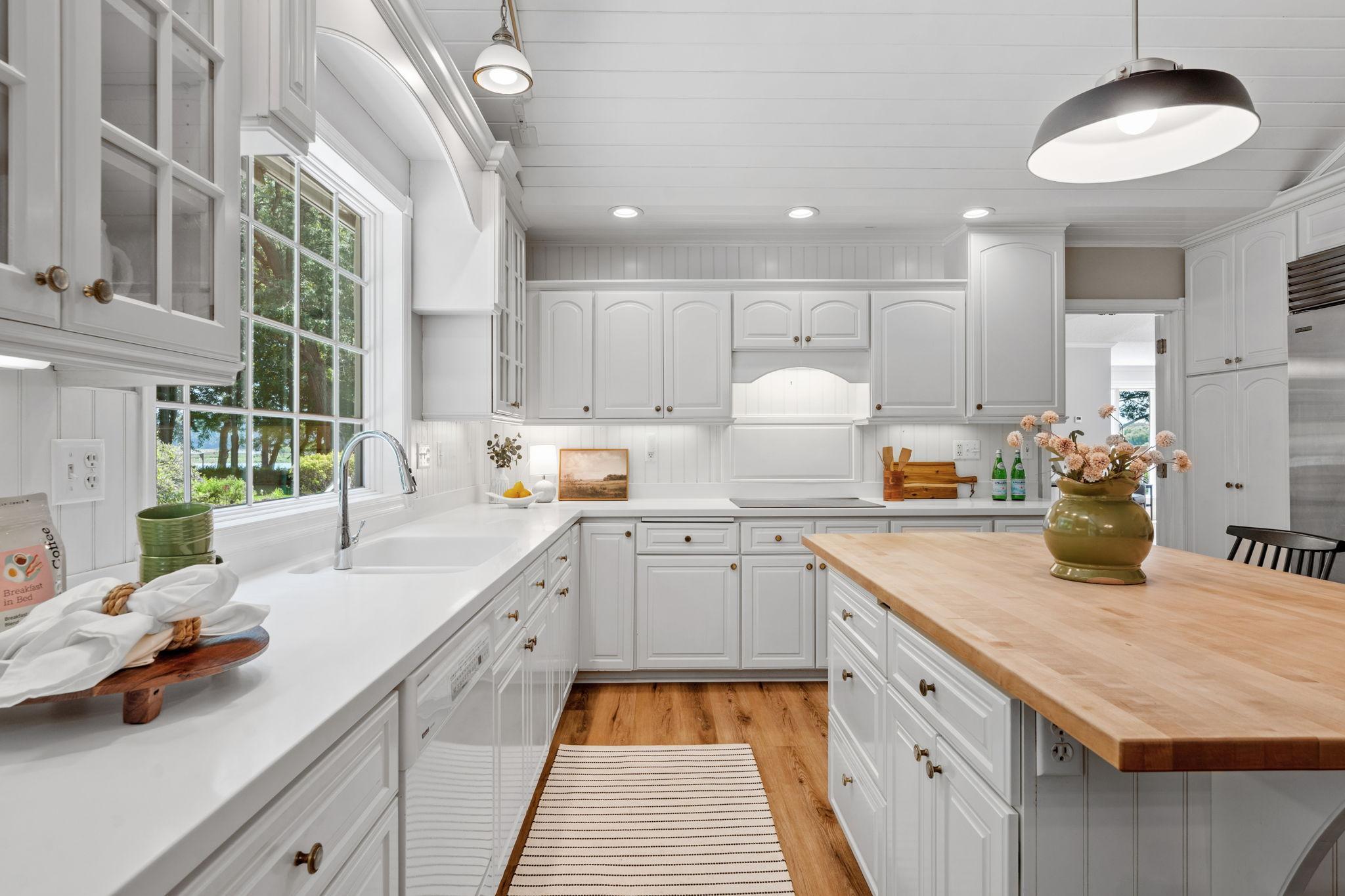 Built in sink with large kitchen window overlooking side gardens.