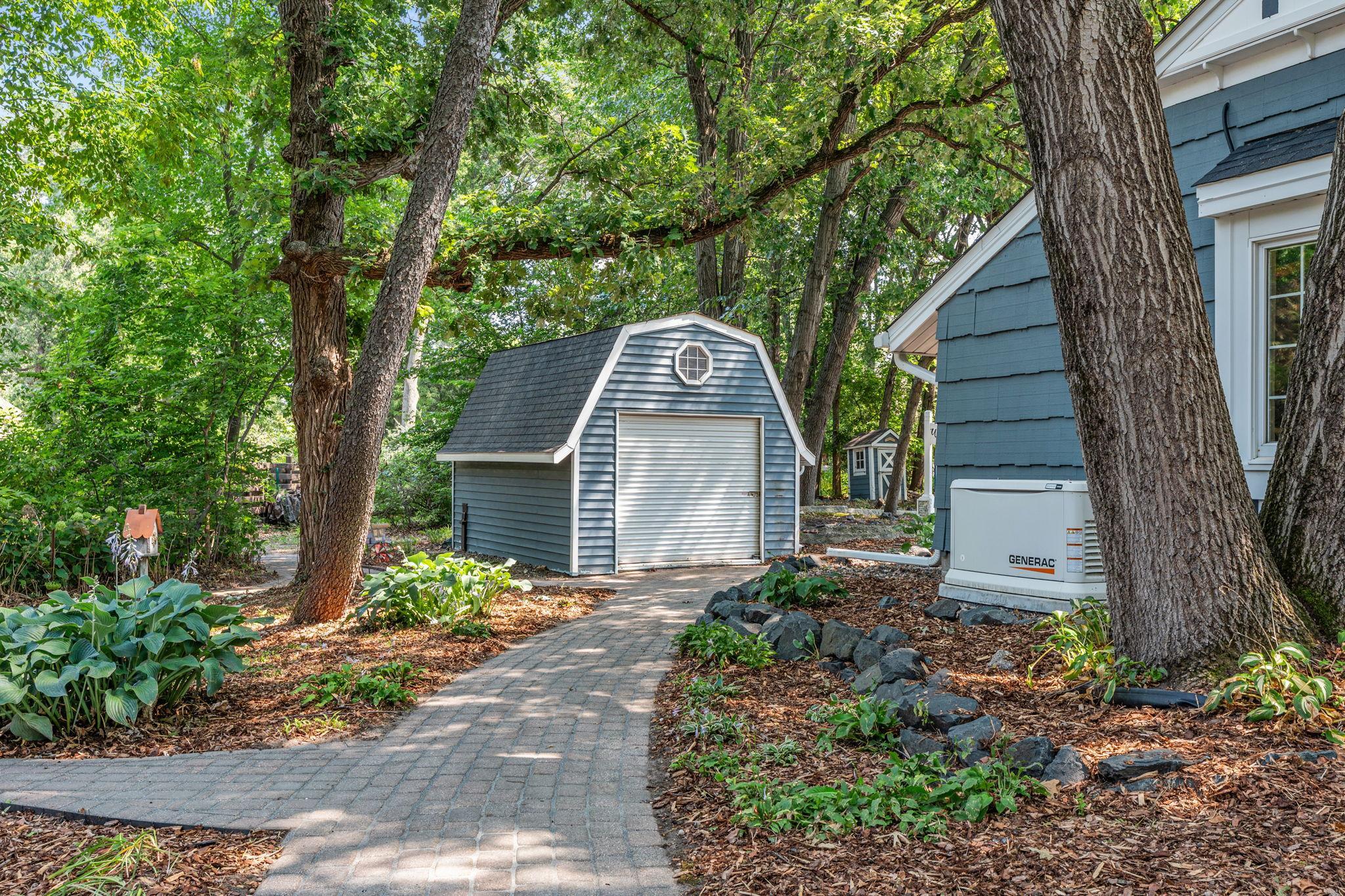 Home has a back up generator and large storage shed. Brick pathways lead you around the magical grounds.