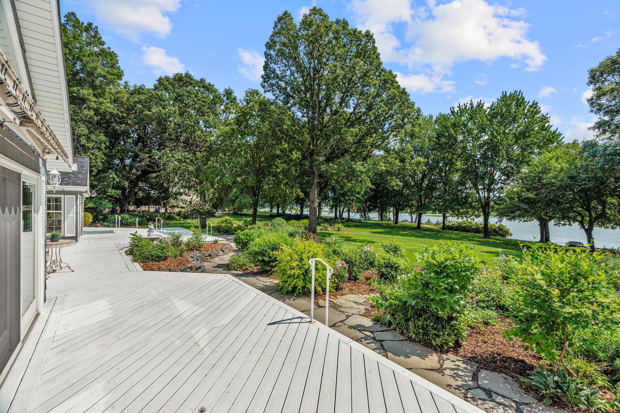 Landscaping recently mulched. Don't miss the lawn sprinkler system that uses a water pump from the river.