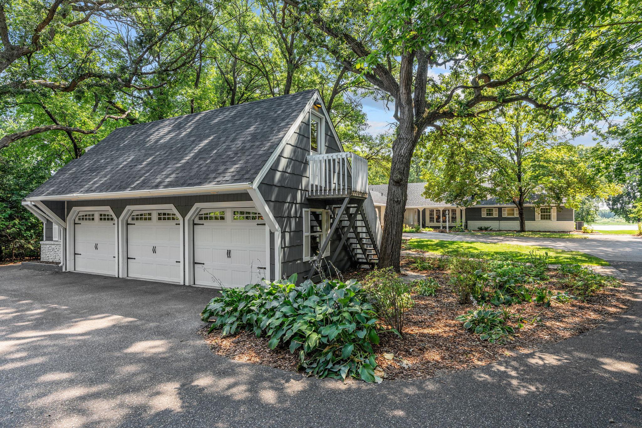 View of detached garage and home.