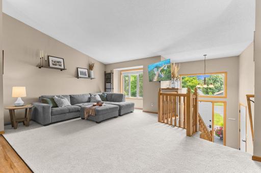 Main Level Living Room with vaulted ceiling & natural lighting