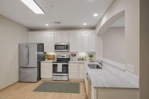 Stunning granite counters, undermount sink, and stainless steel appliances.