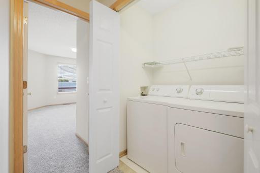 Laundry room with side-by side washer and dryer that stay with the home.