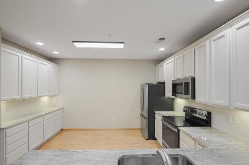Check out the size of this kitchen! BONUS wall of cabinetry and countertops that not many of these homes have! Great space for buffets or all your extra kitchen gadgets.