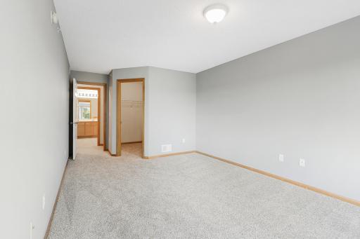 Primary bedroom walk-in closet and full bathroom just outside the bedroom door.
