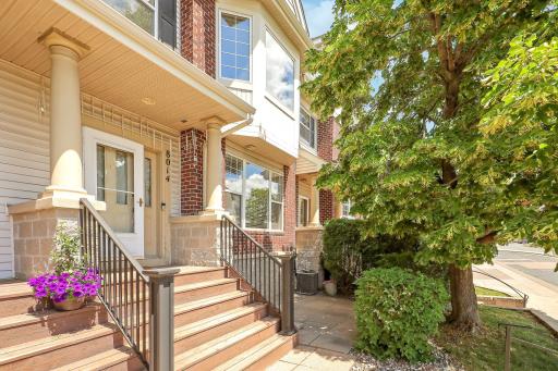 Brick-accented, 2-bed, 2-bath, 2-car row townhome with southern exposure and heated underground parking! Enjoy entertaining on your front patio - a great spot to grill!