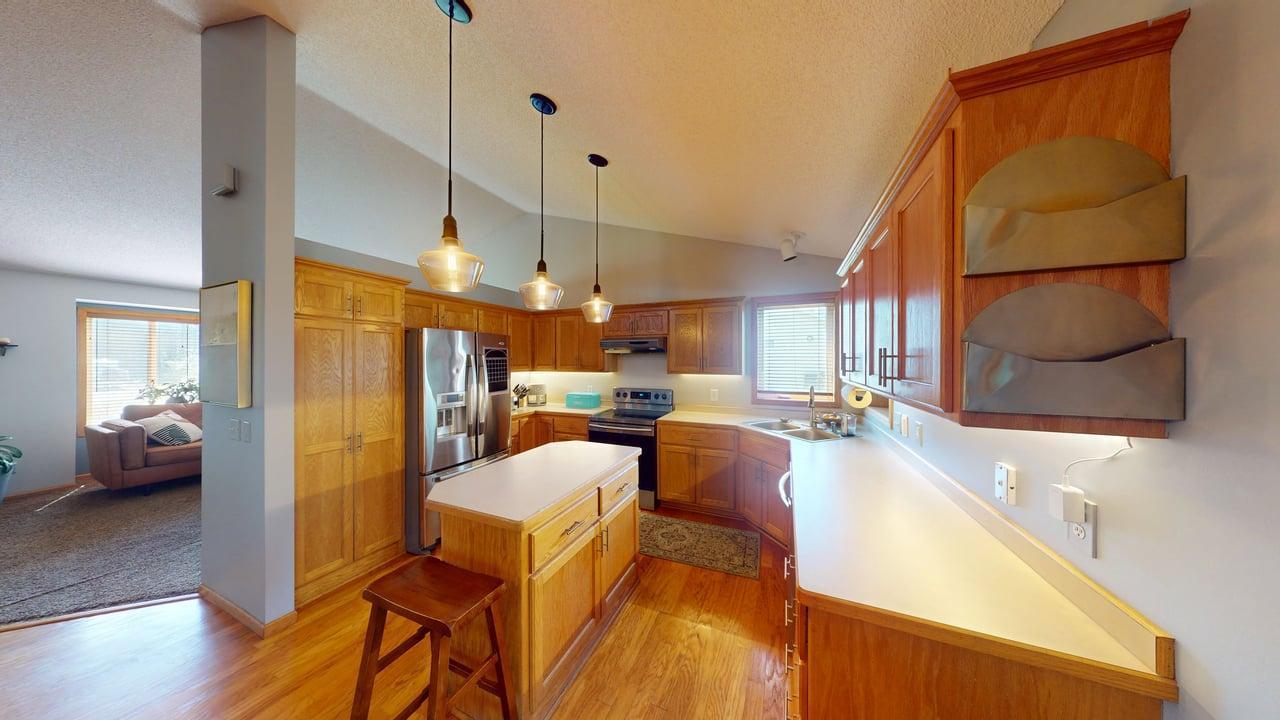 The center island adds extra storage and additional seating—perfect for meal prep or casual dining.