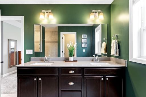 Dual sinks and deep drawer storage keep morning routines organized at the double vanity.