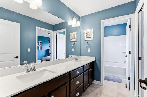 A double vanity Jack & Jill bath serves the secondary bedrooms, with the tub and shower behind their own door so mornings run smoothly.