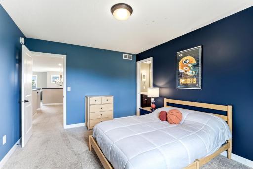 Bold color blocking and easy bath access make this bedroom a favorite kid suite.