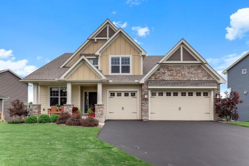 Stone accents, board and batten siding, and layered gables give this craftsman two-story standout curb appeal from the street.