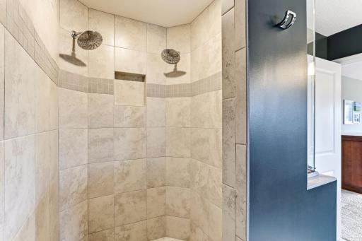 Two shower heads and floor-to-ceiling tile make the walk-in shower the best part of the morning.