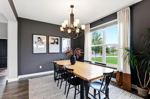 Dramatic color and generous windows make the dining room glow by day and feel intimate by night.
