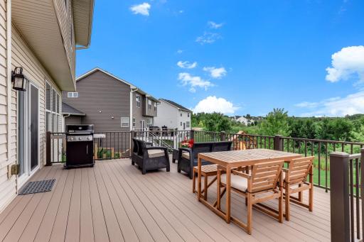 The expansive deck hosts grill nights and golden-hour dinners high above the backyard.