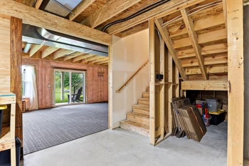 The walkout lower level is framed, insulated, and ready for your vision, with sliding doors and daylight windows already in place.