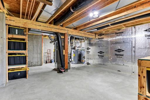 Mechanicals and storage shelving stay neatly tucked into their own corner of the lower level.