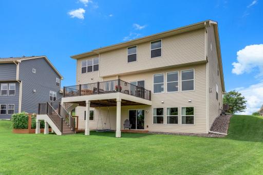 From the back, the scale shows: three levels of living, a full-width deck, and a walkout lower level.