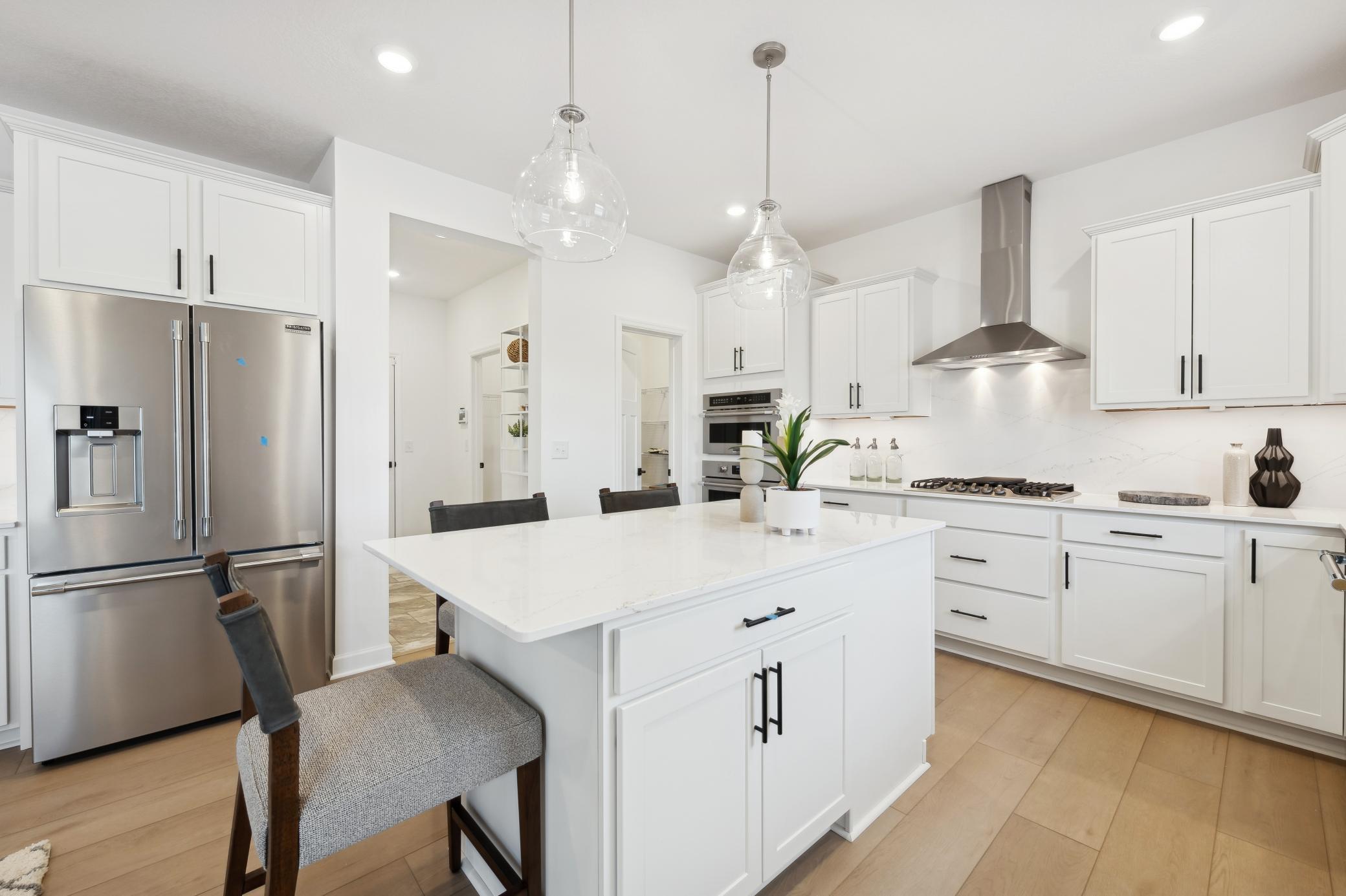(Photo of a similar home, features will vary) Always bright and light filled, this home will feature a sliding glass door next to the dinner table!