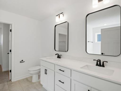 The en-suite bathroom has dual sinks to simplify any morning routine
