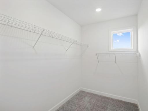The walk-in closet offers ample space and storage