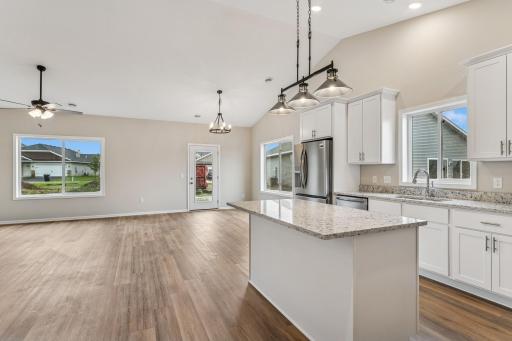 Well equipped and open Kitchen with walk-in pantry, island, soft close cabinetry, granite countertops and gorgeous luxury wide plank floors and vaulted ceilings.
