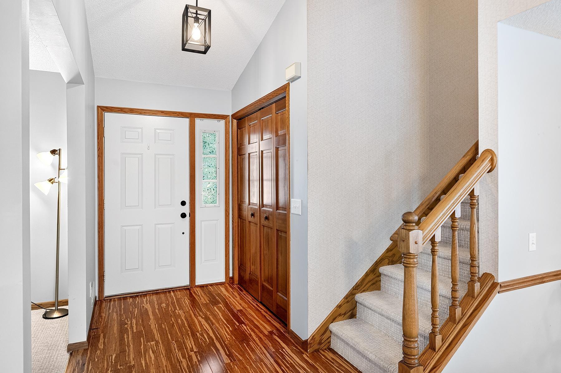 Foyer with large coat closet. Stairs leading to upper level. Den/family room to the left. New carpet in den, stairs and all second level (and living room).