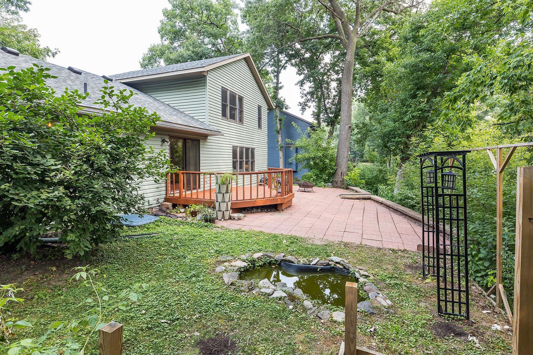 Private backyard with water feature and raised bed for gardening.