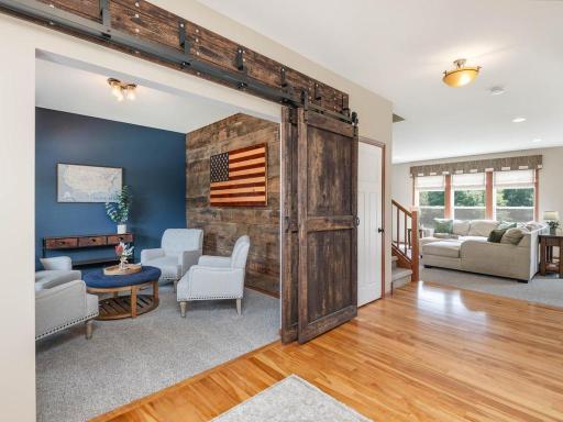 Front flex room with barn wood wall and barn doors.