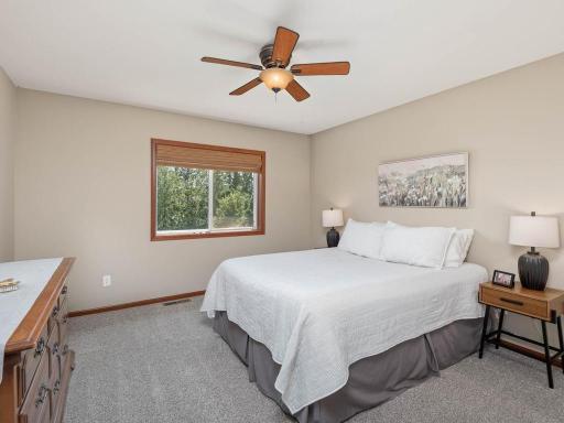 This bedroom has a view of the backyard and is generously sized with a walk in closet