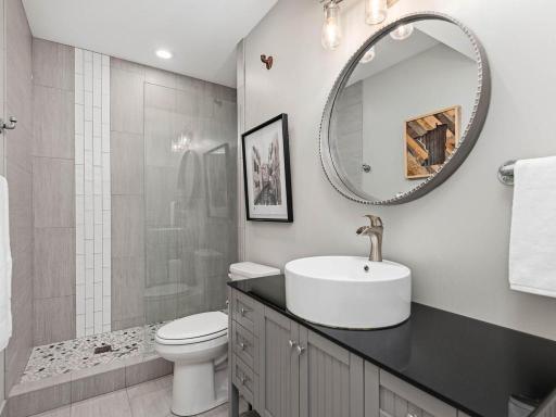 Gorgeous bathroom with tiled walk in shower.