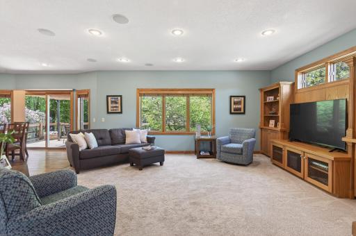 Living room features a cozy gas fireplace, built-ins, and beautiful views of the backyard