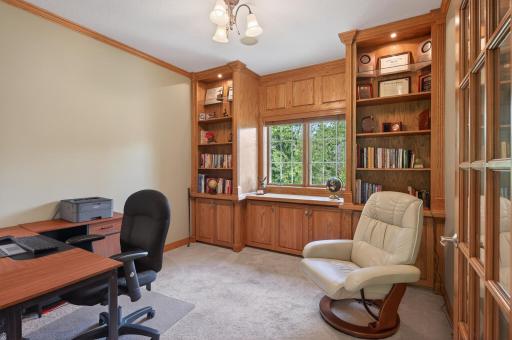 Main level office with custom built-ins and glass french door