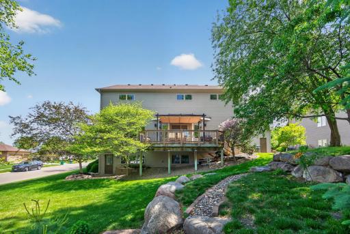 Thougthfully landscaped backyard with firepit, hot tub and maintenance-free deck