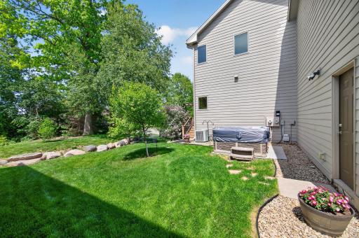 Thougthfully landscaped backyard with firepit, hot tub and maintenance-free deck