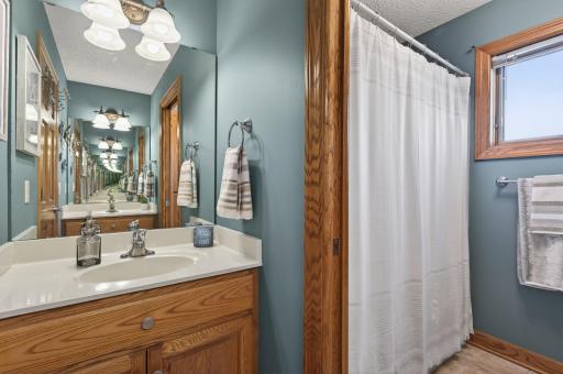 Upper level bathroom with thoughtfully-designed separation offered between the two vanities and the shower/toilet area