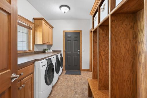 Incredible mudroom with laundry (including 2 dryers) and built-in cubby storage