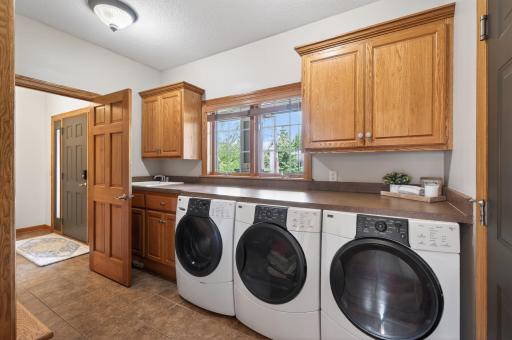 Incredible mudroom with laundry (including 2 dryers) and built-in cubby storage