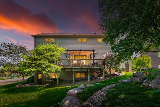 Thougthfully landscaped backyard with firepit, hot tub and maintenance-free deck