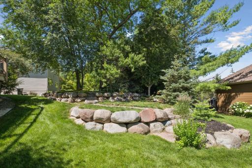 Thougthfully landscaped backyard with firepit, hot tub and maintenance-free deck