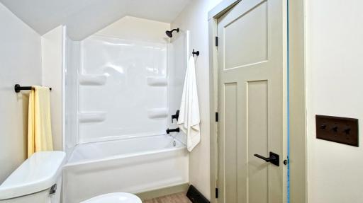 New tub and shower surround in upper level full bath.