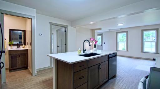 1/2 bath to the left and the primary bedroom is through the door to the right of the bathroom.