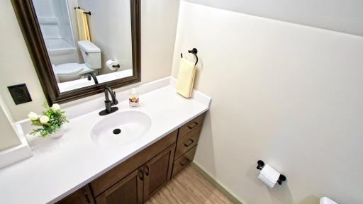 Full bath on upper level has a new vanity as well as new luxury vinyl planking.