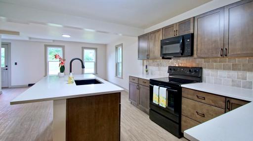Gorgeous kitchen with new center island that boasts a countertop eating area.