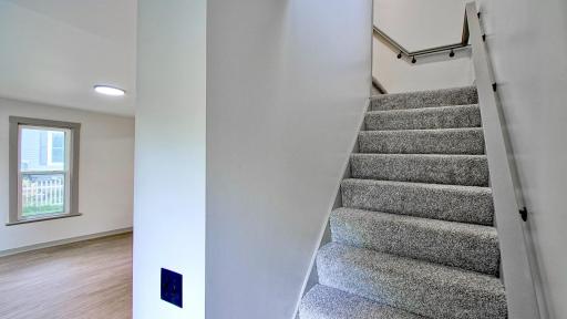 Stairs from the upper level. Living room is to the left.