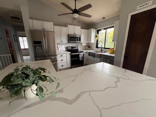 WOW! Look those gorgeous counter tops in the remodeled kitchen